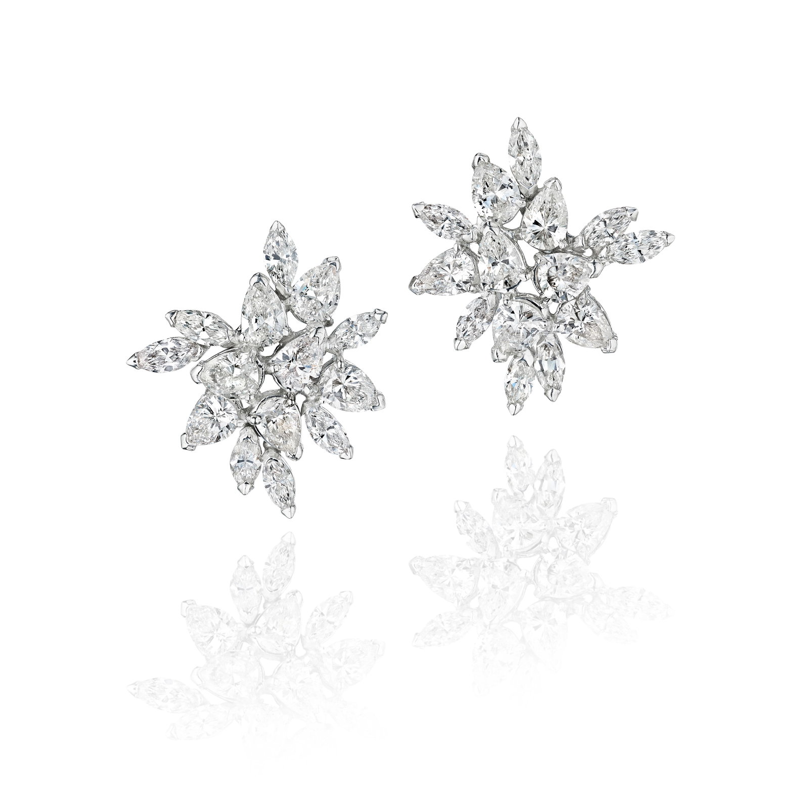 A PAIR OF DIAMOND EARRINGS: A PAIR OF DIAMOND EARRINGS Each designed as a cluster of pear and marquise-shaped diamonds; estimated total diamond weight 13.10 carats; mounted in 14K white gold; length 1¼ in For further