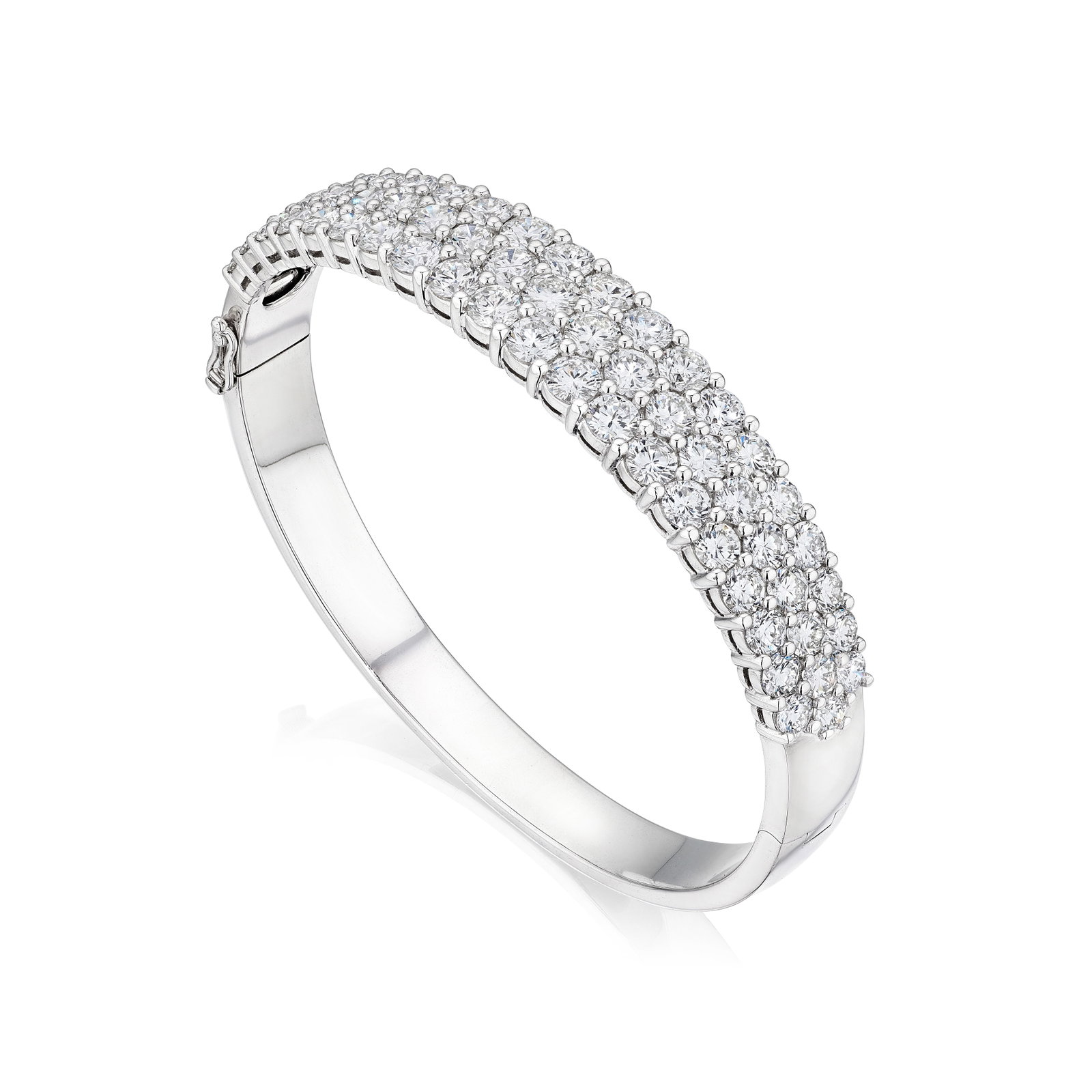 A DIAMOND BANGLE: A DIAMOND BANGLE Of bangle design, accented by three rows of round brilliant-cut diamonds; estimated total diamond weight 9.95 carats; mounted in 18K white gold; inner circumference 6½ in For