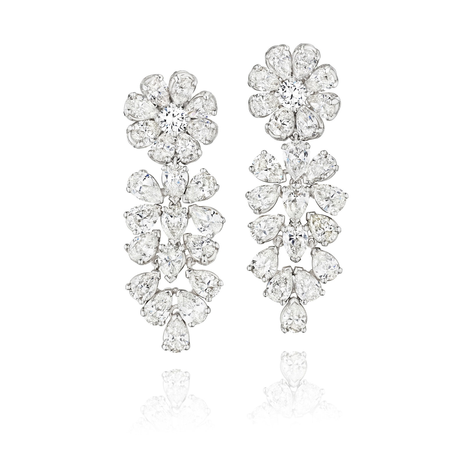 A PAIR OF DIAMOND EARRINGS: A PAIR OF DIAMOND EARRINGS Each designed as a flower head with pear-shaped diamond petals and a round brilliant-cut diamond stamen, suspending clustered pear-shaped diamonds; estimated total diamond