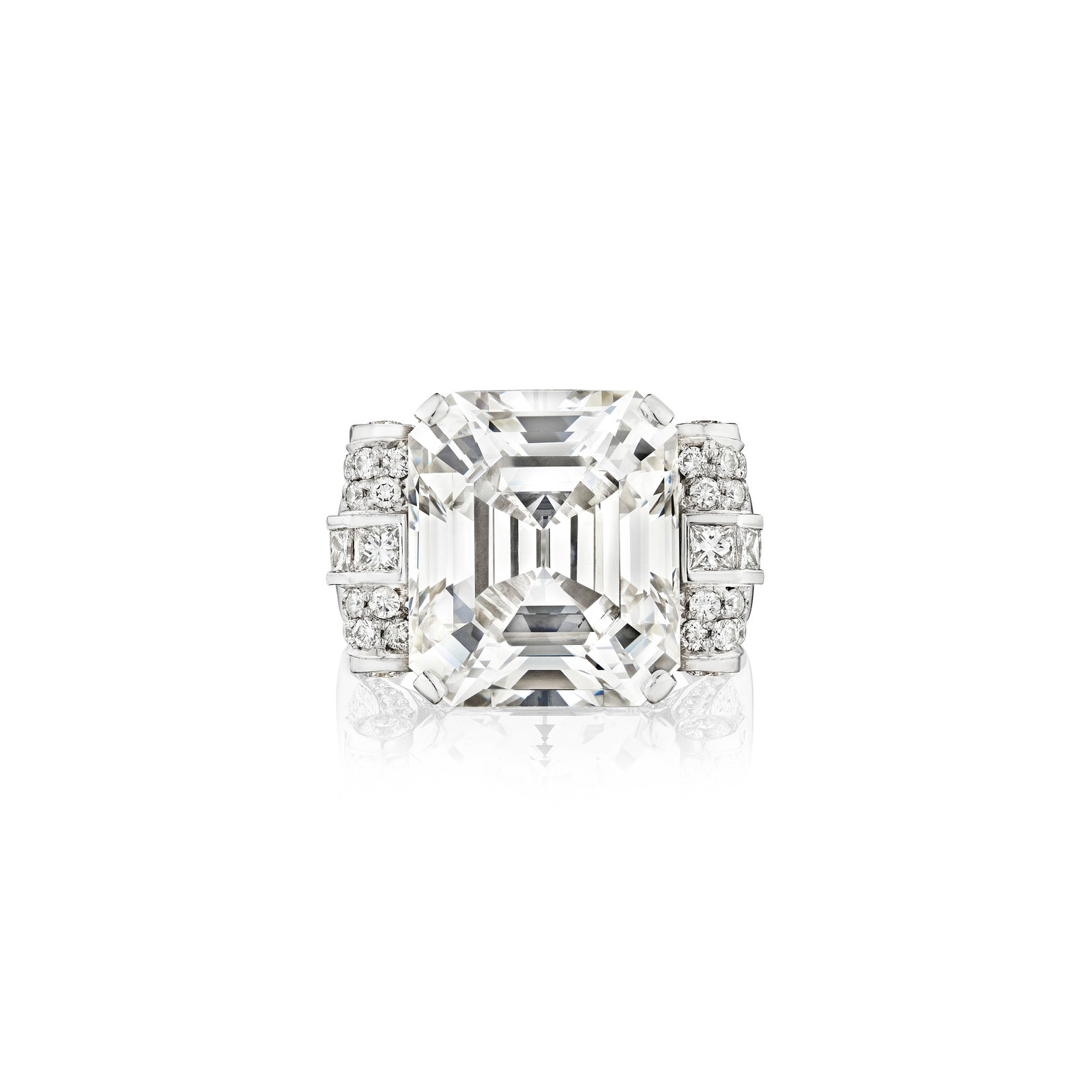 A DIAMOND RING: A DIAMOND RING Centering an emerald-cut diamond, weighing 14.49 carats, framed by round brilliant and princess-cut diamonds; estimated total remaining diamond weight 1.80 carats; mounted in 18K white