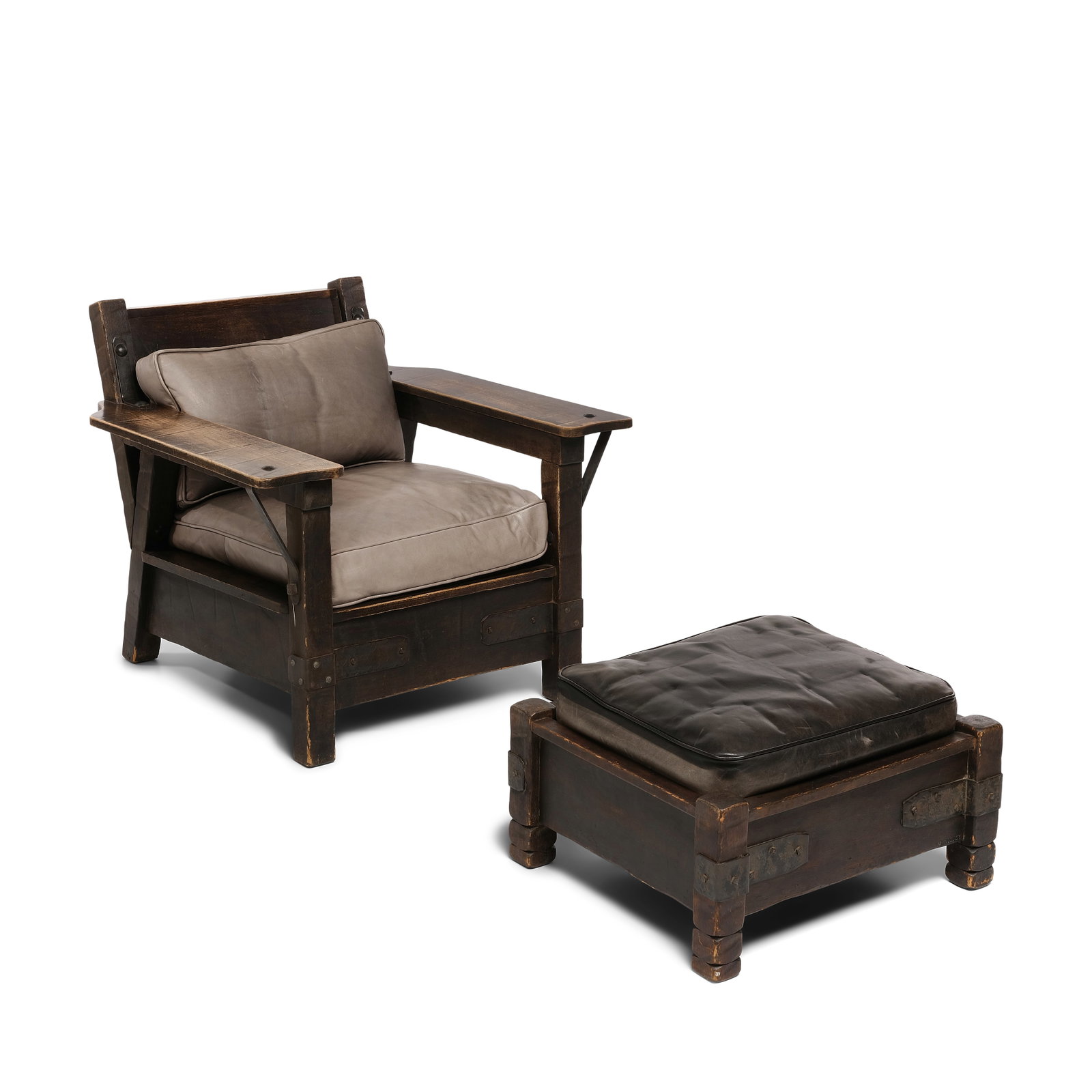 A MONTEREY IRON MOUNTED PAINT DECORATED AND OLD WOOD STAINED CLUB CHAIR AND OTTOMANCirca 1930: A MONTEREY IRON MOUNTED PAINT DECORATED AND OLD WOOD STAINED CLUB CHAIR AND OTTOMAN Circa 1930 Each branded with horseshoe insignia, with black leather cushions. height of chair 30 1/2in; width 35in; 