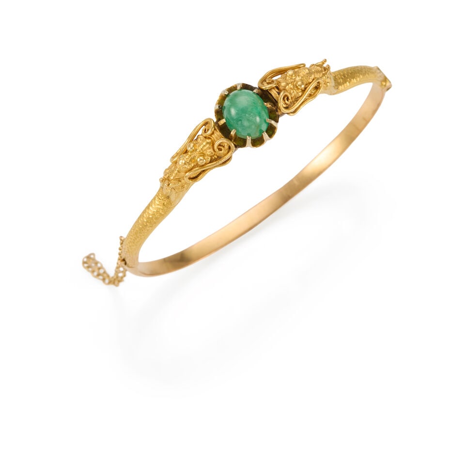 GOLD AND EMERALD BANGLE: GOLD AND EMERALD BANGLE • 14K and 20K yellow gold • One oval cabochon emerald weighing approximately 2.80 carats • Inner circumference 6 3/4 in. • Estimated gross weight: 25.2