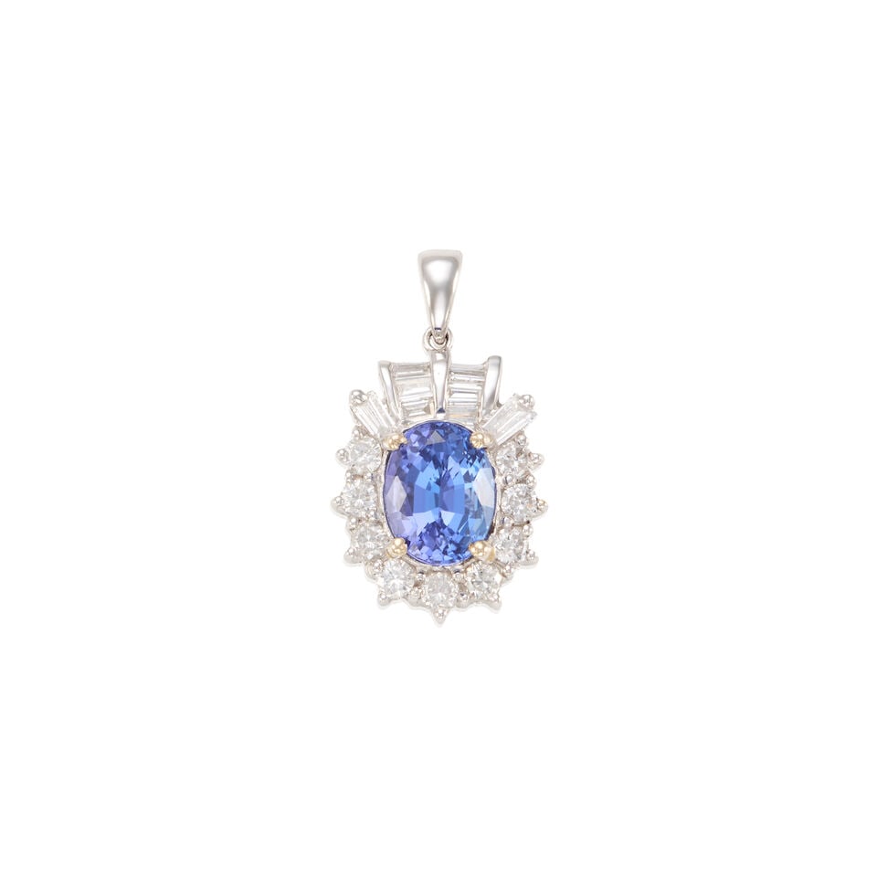 18K GOLD, TANZANITE, AND DIAMOND PENDANT: 18K GOLD, TANZANITE, AND DIAMOND PENDANT • 18K white gold • One oval shaped tanzanite weighing approximately 2.70 carats • Nine round brilliant cut diamonds weighing approximately 0.