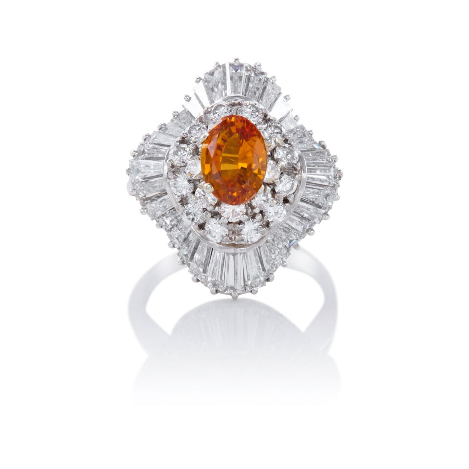 18K GOLD, SAPPHIRE, AND DIAMOND RING: 18K GOLD, SAPPHIRE, AND DIAMOND RING • 18K white gold • One oval shaped sapphire weighing approximately 1.20 carats • Numerous round brilliant cut diamonds weighing approximately 0.4