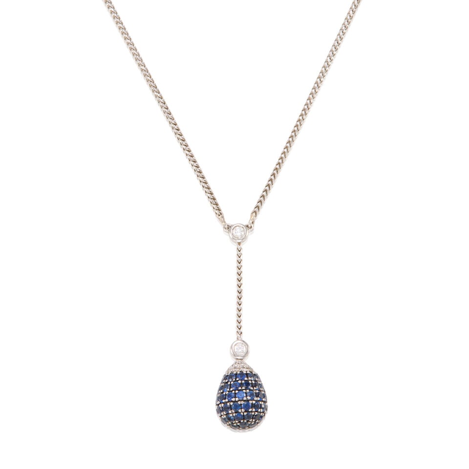 18K GOLD, SAPPHIRE, AND DIAMOND PENDANT NECKLACE: 18K GOLD, SAPPHIRE, AND DIAMOND PENDANT NECKLACE • 18K white gold • Numerous round shaped sapphires weighing approximately 1.30 carats total • Numerous round shaped diamonds
