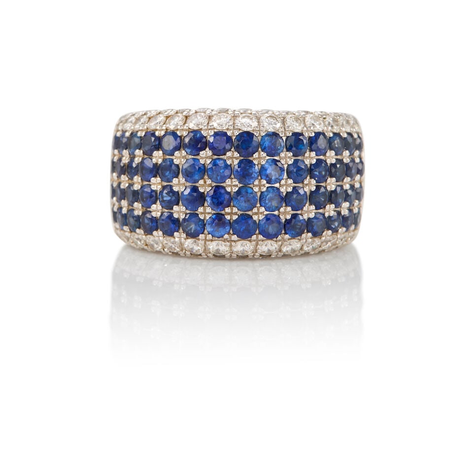 18K GOLD, SAPPHIRE, AND DIAMOND RING: 18K GOLD, SAPPHIRE, AND DIAMOND RING • 18K white gold • Numerous round shaped sapphires weighing approximately 2 carats total • Numerous round shaped diamonds weighing approximately 
