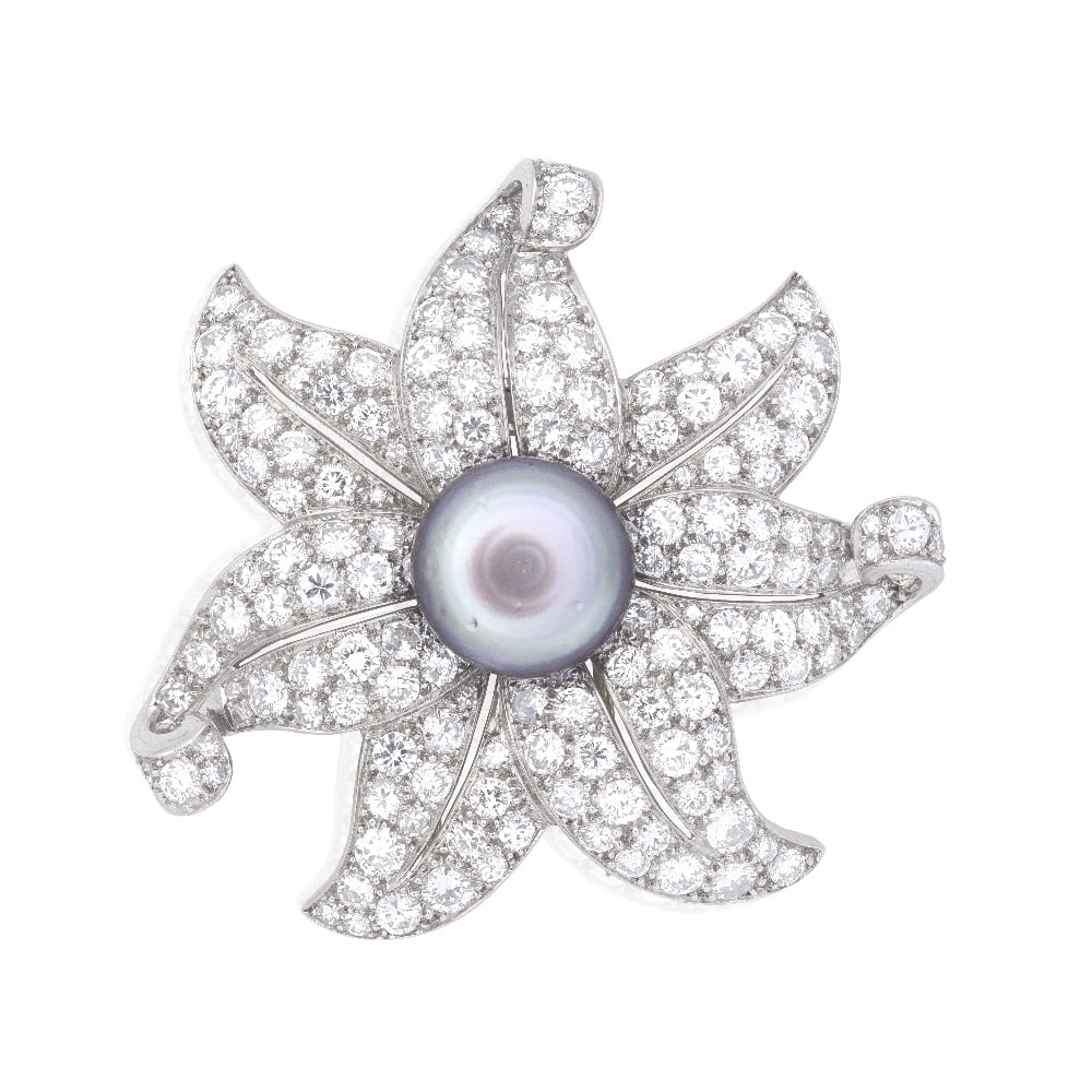 NATURAL PEARL AND DIAMOND FLOWER CLIP, CIRCA 1935: NATURAL PEARL AND DIAMOND FLOWER CLIP, CIRCA 1935 The 13.4mm x 9.1mm bouton-shaped natural pearl of grey tint, within a surround of unfurling petals, pavé-set throughout with brilliant and