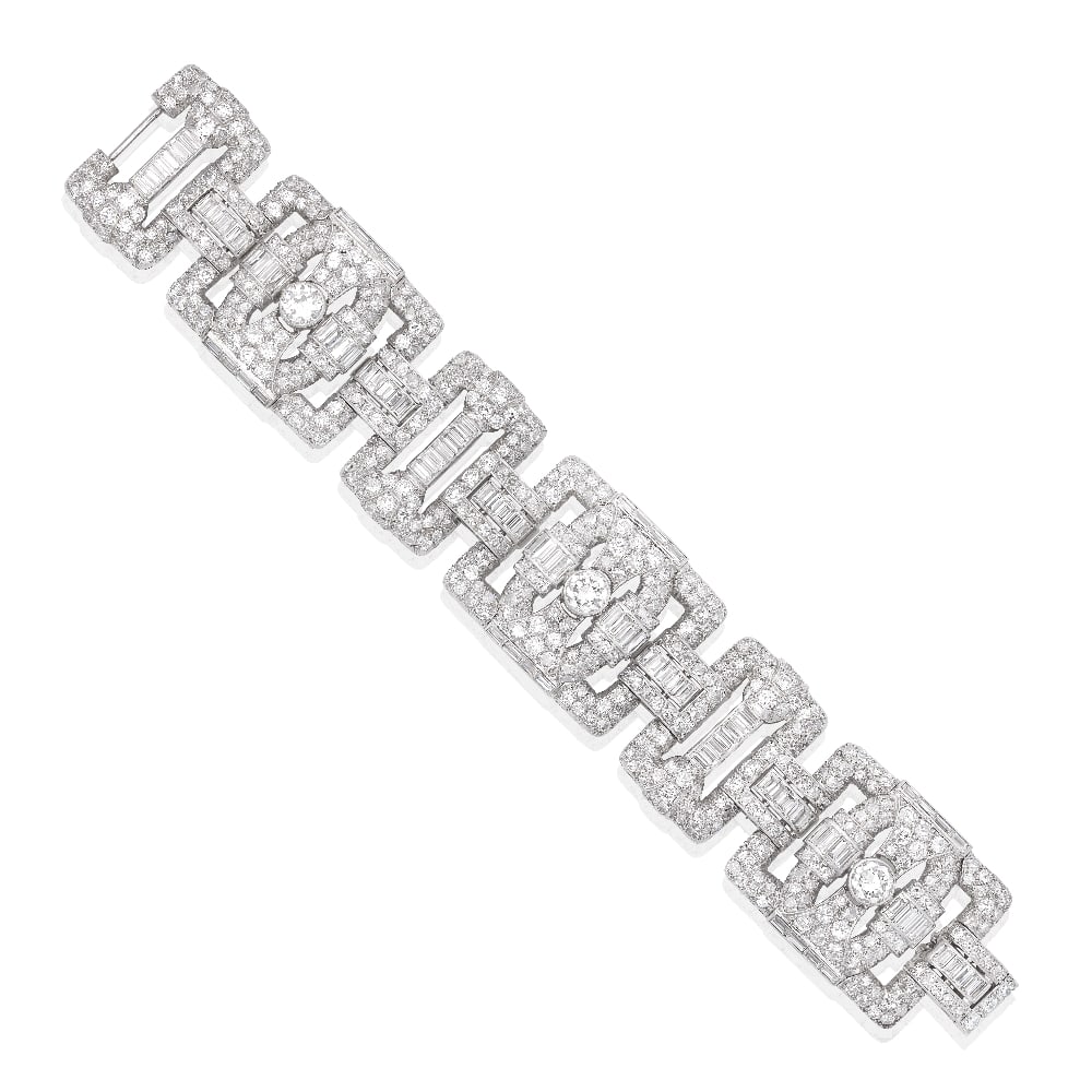 DIAMOND STRAP BRACELET, CIRCA 1930: DIAMOND STRAP BRACELET, CIRCA 1930 The geometric openwork links of buckle form, set throughout with old brilliant, single and baguette-cut diamonds, mounted in platinum, French assay marks, diamonds