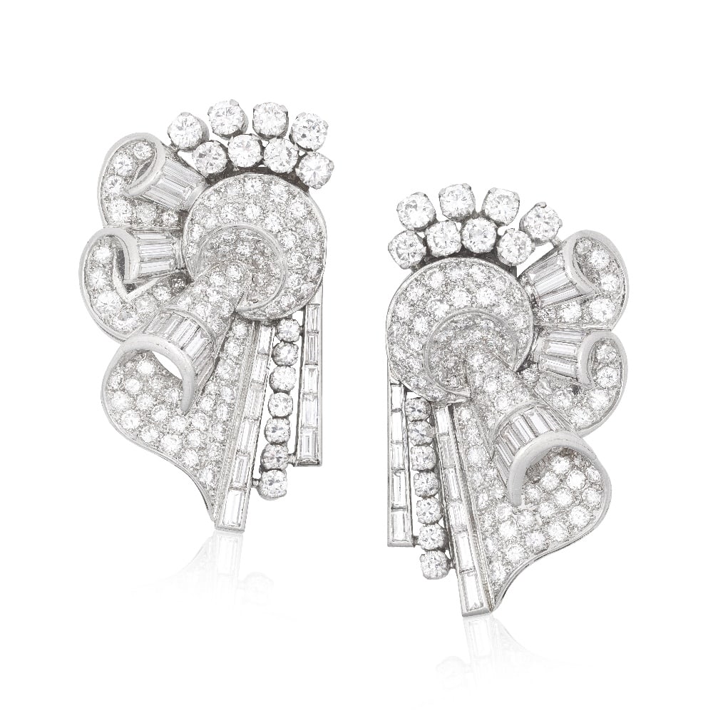 DIAMOND DOUBLE-CLIP BROOCH, CIRCA 1950: DIAMOND DOUBLE-CLIP BROOCH, CIRCA 1950 Each clip with scrolls of baguette and old brilliant-cut diamonds, with circular bombé and concave plaques set with old brilliant-cut diamonds, accented by 