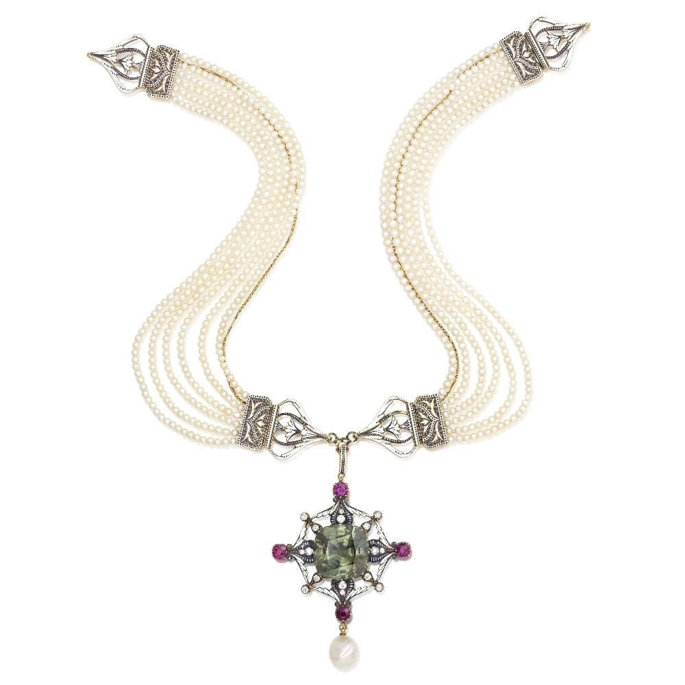 CARLO GIULIANO: PEARL, SEED PEARL, ZIRCON, ENAMEL AND GEM-SET PENDANT NECKLACE, CIRCA 1895: CARLO GIULIANO: PEARL, SEED PEARL, ZIRCON, ENAMEL AND GEM-SET PENDANT NECKLACE, CIRCA 1895 The openwork pendant with foliate detail finely decorated in monochrome enamel, set with a cushion-cut green