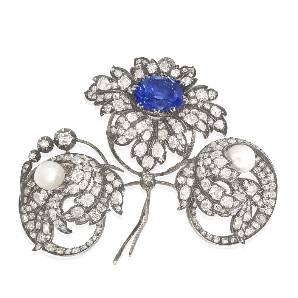 SAPPHIRE AND DIAMOND FLORAL SPRAY BROOCH, CIRCA 1890: SAPPHIRE AND DIAMOND FLORAL SPRAY BROOCH, CIRCA 1890 The oval-cut sapphire weighing 15.94 carats, forming the centre of a flowerhead, highlighted by old pear, cushion and rose-cut diamonds,