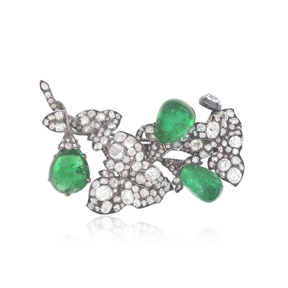 EMERALD AND DIAMOND BROOCH, CIRCA 1880: EMERALD AND DIAMOND BROOCH, CIRCA 1880 Realistically modelled as ivy leaves, set throughout with old cushion, old brilliant and rose-cut diamonds, issuing three pear-shaped cabochon emerald 'buds',