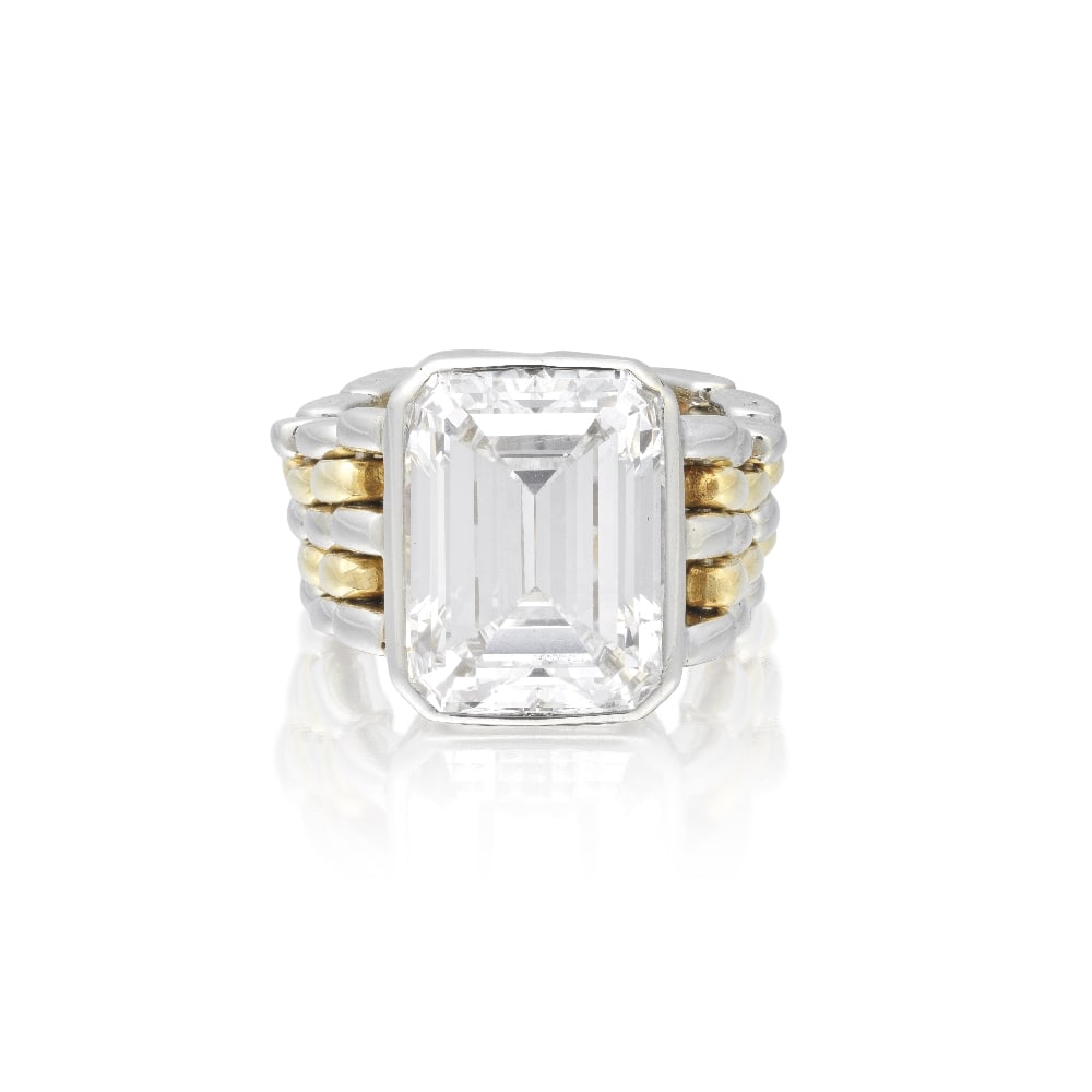 DIAMOND SINGLE-STONE RING: DIAMOND SINGLE-STONE RING The step-cut diamond, weighing 7.01 carats, in a collet-setting on a flexible bicoloured band of brick-linking, ring size K Footnotes: Accompanied by a report from GIA statin