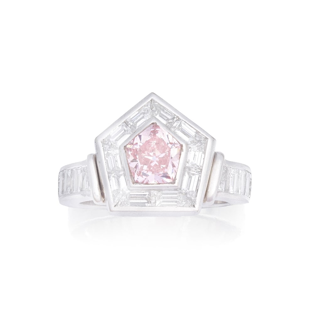 FANCY COLOURED DIAMOND RING: FANCY COLOURED DIAMOND RING The Fancy Pink pentagonal brilliant-cut diamond, weighing 1.01 carats, within a step-cut diamond surround, to similarly set step-cut diamond shoulders, remaining diamonds