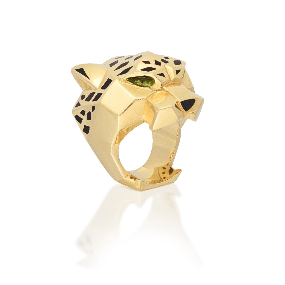 CARTIER: GEM-SET 'PANTHÈRE DE CARTIER' RING: CARTIER: GEM-SET 'PANTHÈRE DE CARTIER' RING The panther head with black lacquer spots, pear-cut peridot eyes and an onyx nose, signed Cartier, numbered PVD974, maker's mark, French and Swiss