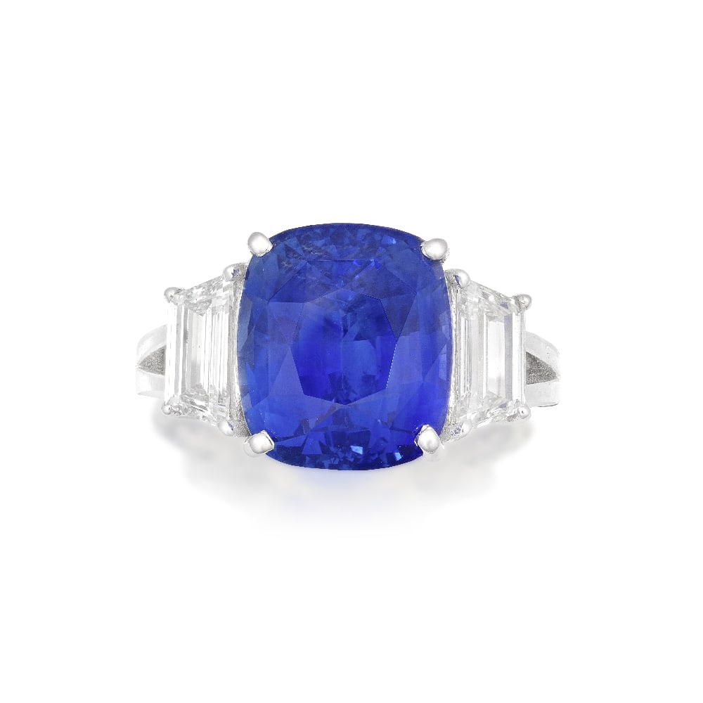 SAPPHIRE AND DIAMOND RING: SAPPHIRE AND DIAMOND RING The cushion-shaped sapphire weighing 7.76 carats, between step-cut diamonds, ring size I Footnotes: Accompanied by a report from GRS stating that the sapphire is of Sri Lanka