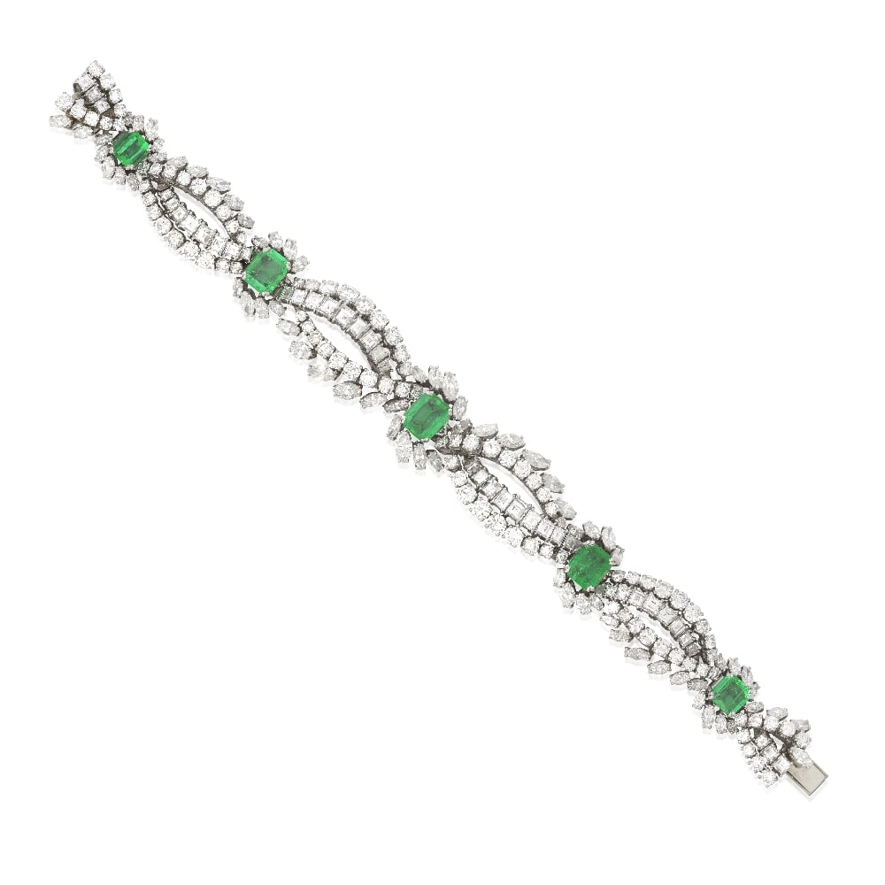 EMERALD AND DIAMOND BRACELET: EMERALD AND DIAMOND BRACELET Composed of intertwined ribbons of brilliant, marquise and step-cut diamonds, accented by octagonal step-cut emeralds within marquise-cut diamond surrounds, emeralds