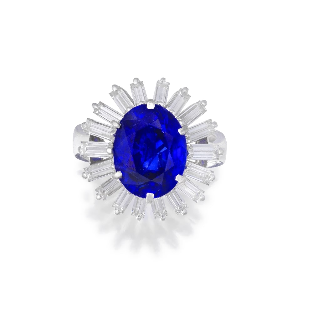 SAPPHIRE AND DIAMOND RING: SAPPHIRE AND DIAMOND RING The oval-cut sapphire weighing 4.94 carats, within a ballerina surround undulating with baguette-cut diamonds, diamonds approximately 2.00 carats total, ring size K (band of