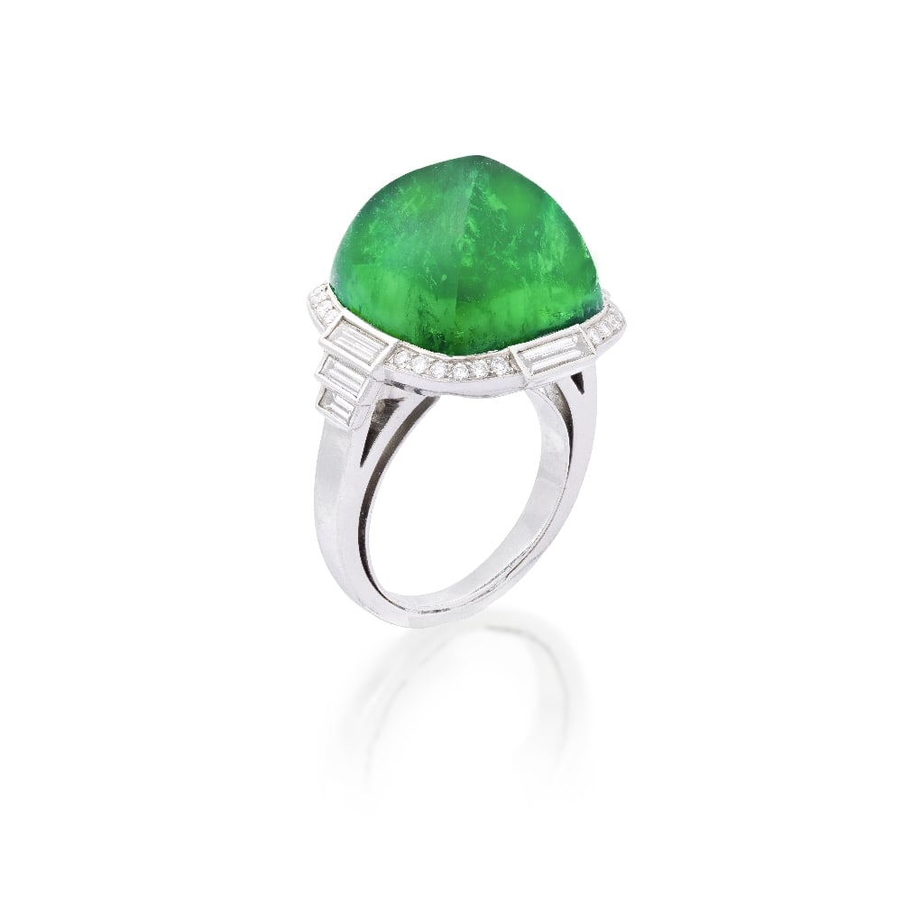 EMERALD AND DIAMOND RING: EMERALD AND DIAMOND RING The sugarloaf cabochon emerald, weighing 14.39 carats, within a surround of baguette and brilliant-cut diamonds, stepped baguette-cut diamond shoulders, ring size H (sizing