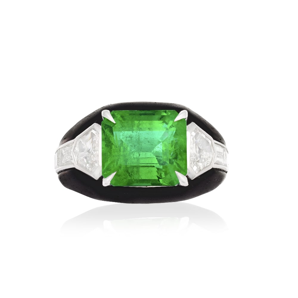 EMERALD AND DIAMOND RING: EMERALD AND DIAMOND RING The octagonal step-cut emerald weighing 5.78 carats between shield-cut diamonds, to a baguette-cut diamond and carbon fibre mount, diamonds very approximately 2.50cts, ring