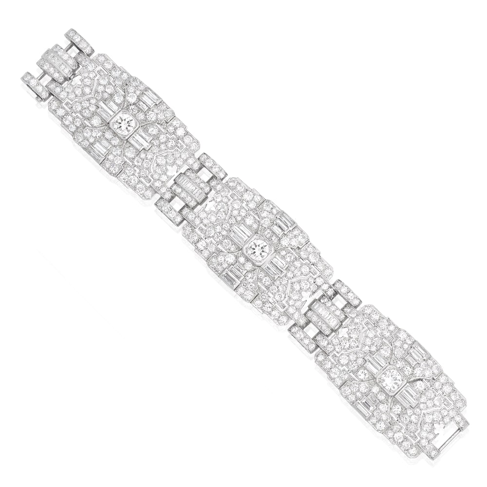 DIAMOND BRACELET, CIRCA 1930: DIAMOND BRACELET, CIRCA 1930 Of openwork geometric design, the articulated strap set throughout with old brilliant diamonds, each panel with pierced detail, a central old brilliant-cut diamond, with