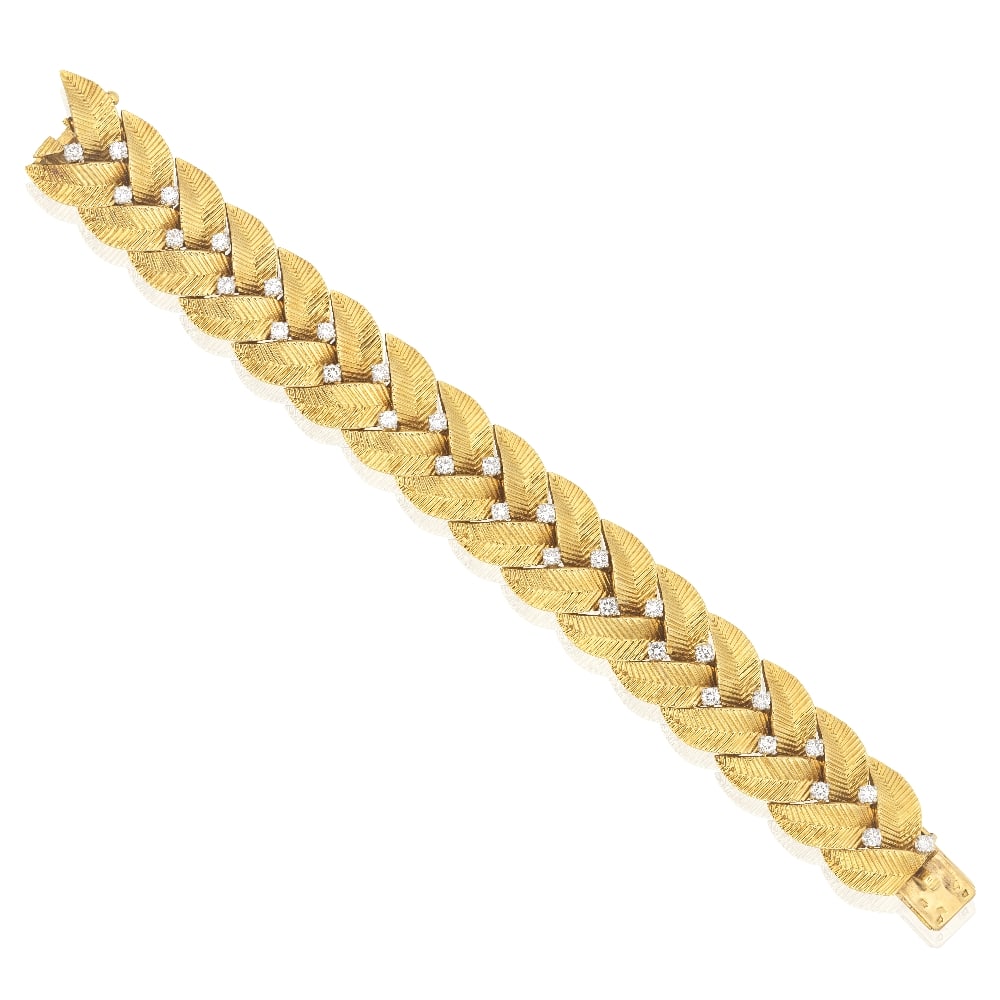 CARTIER: DIAMOND-SET BRACELET, CIRCA 1955: CARTIER: DIAMOND-SET BRACELET, CIRCA 1955 Of braided foliate design, accented by brilliant-cut diamonds, signed Cartier Paris, numbered 09515 (rubbed), French workshop mark (rubbed), French assay