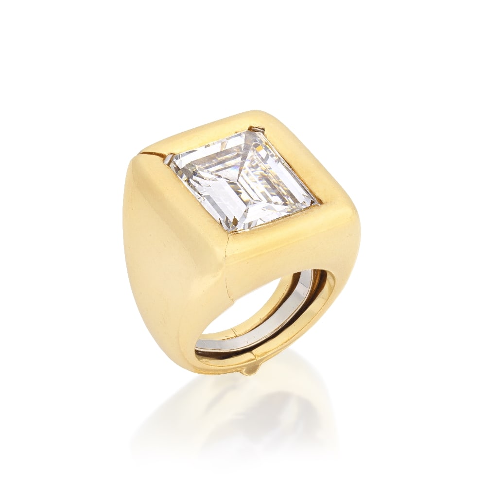 DIAMOND SINGLE-STONE RING: DIAMOND SINGLE-STONE RING The step-cut diamond weighing 11.13 carats, between baguette-cut diamond shoulders, accompanied by a hinged ring 'jacket', jacket mount signed A. Clunn (Andrew Clunn), ring