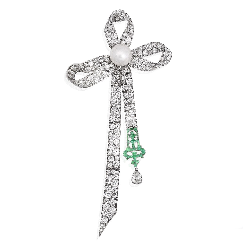 NATURAL PEARL, DIAMOND AND EMERALD BOW BROOCH: NATURAL PEARL, DIAMOND AND EMERALD BOW BROOCH The stylised bow, set with a natural pearl to the centre, measuring 10.9-8.2mm, set with old brilliant-cut diamonds, issuing two articulated tassels,