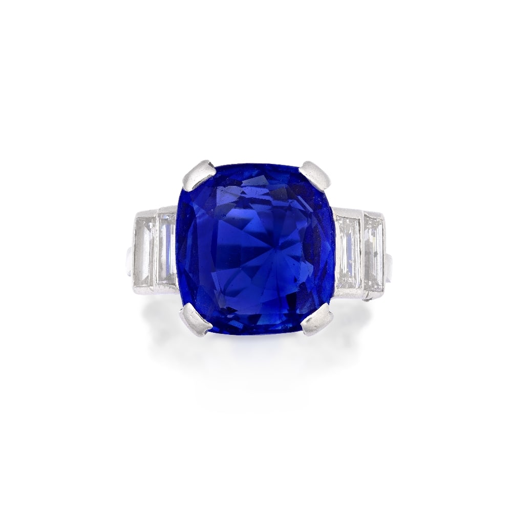 SAPPHIRE AND DIAMOND RING: SAPPHIRE AND DIAMOND RING The cushion-shaped sapphire between baguette-cut diamond shoulders, ring size J½ Footnotes: Accompanied by a report from The Gem & Pearl Laboratory stating that the