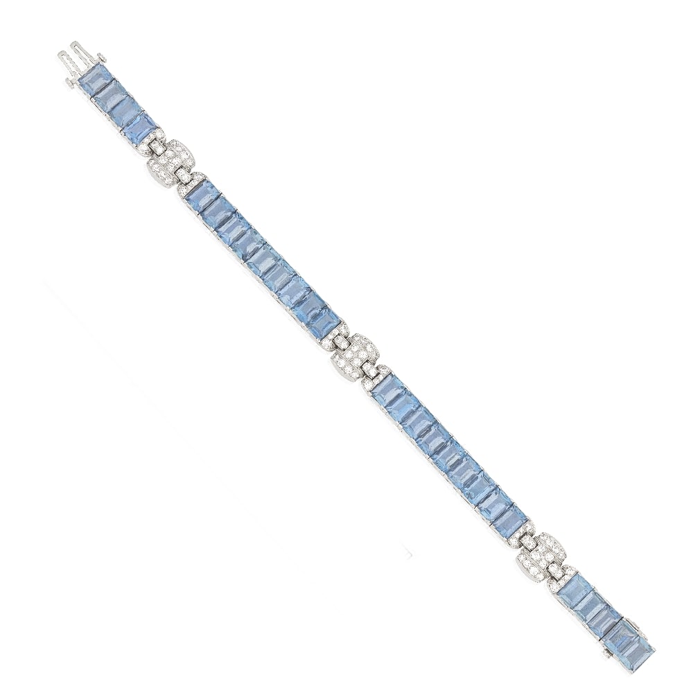 ATTRIBUTED TO OSCAR HEYMAN: AQUAMARINE AND DIAMOND BRACELET, CIRCA 1925: ATTRIBUTED TO OSCAR HEYMAN: AQUAMARINE AND DIAMOND BRACELET, CIRCA 1925 The articulated strap of step-cut aquamarines accented by three pavé-set old brilliant-cut diamond links, mounted in