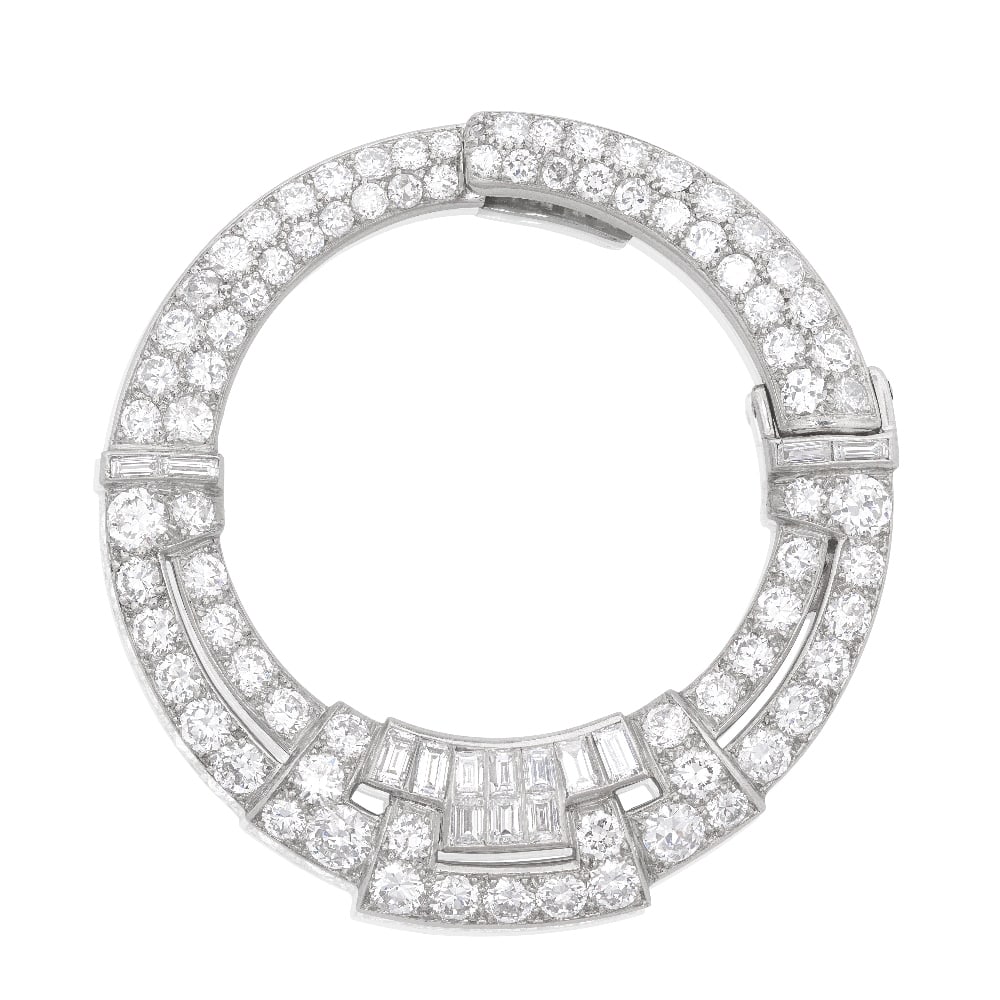 VAN CLEEF & ARPELS: DIAMOND 'UN CERCLE' CLIP, CIRCA 1930: VAN CLEEF & ARPELS: DIAMOND 'UN CERCLE' CLIP, CIRCA 1930 Of pierced annular form, pavé-set throughout with graduated old brilliant-cut diamonds, accented by baguette and step-cut diamonds, mounte