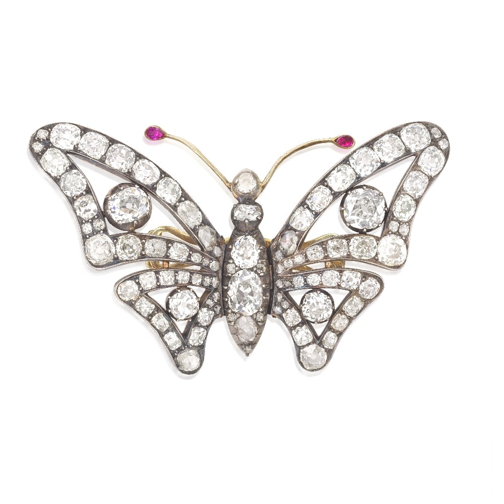 DIAMOND BUTTERFLY BROOCH/HAIR ORNAMENT, MID-19TH CENTURY: DIAMOND BUTTERFLY BROOCH/HAIR ORNAMENT, MID-19TH CENTURY The thorax and openwork wings set throughout with old brilliant, old cushion and rose-cut diamonds, the rose-cut diamond head issuing ruby