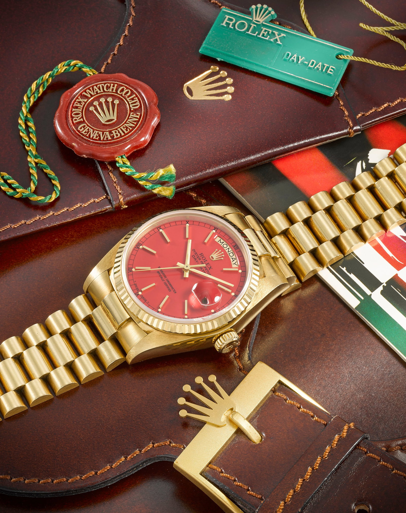 Rolex. A fine and rare 18K gold automatic calendar bracelet watch with stella dial Day-Date, Re...: Rolex. A fine and rare 18K gold automatic calendar bracelet watch with stella dial Model: Day-Date Reference: 1803 Date: Circa 1981 Movement: 27-jewel Cal.3055 automatic, No.0600734 Dial: Red, applied