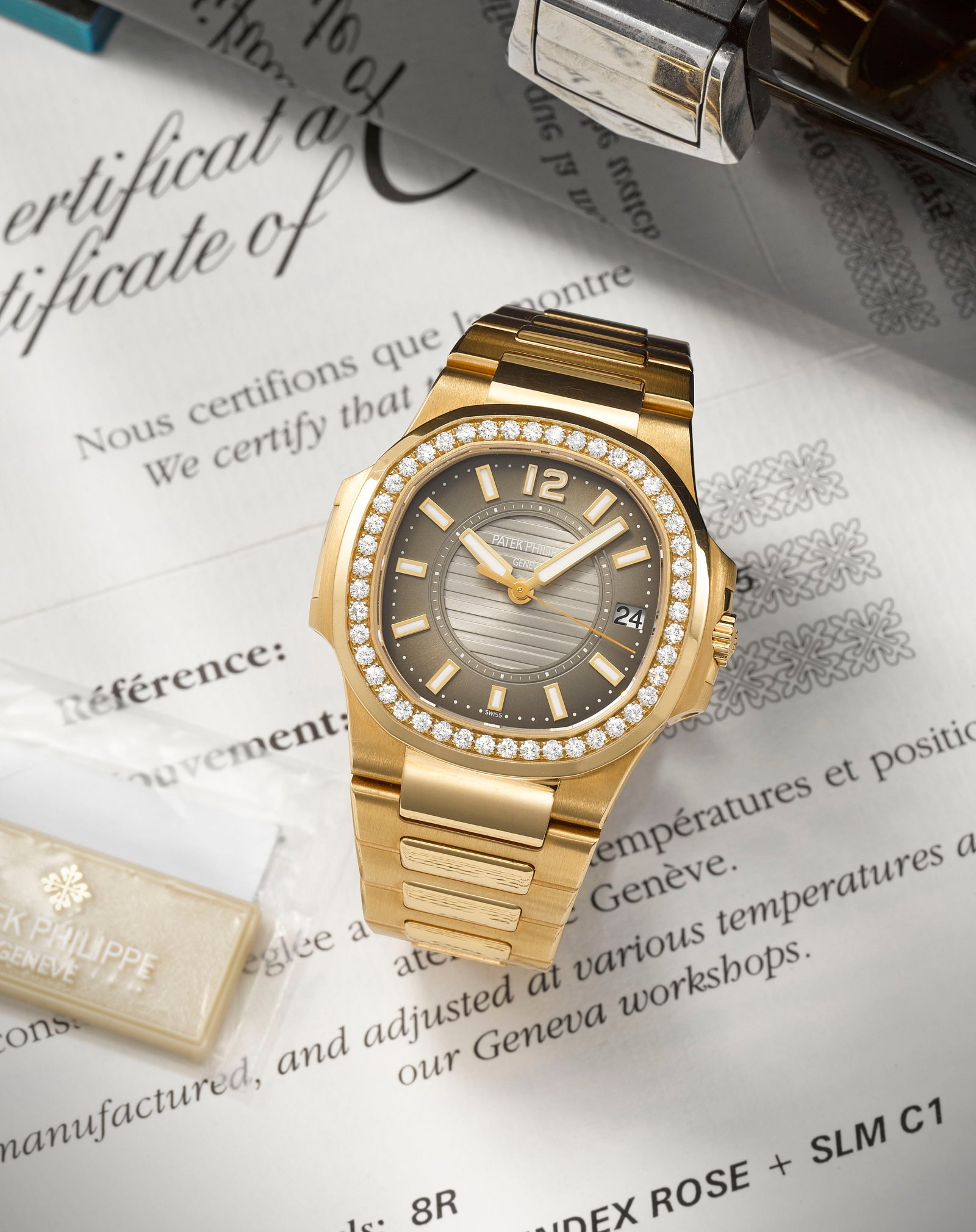 Patek Philippe. A fine lady's 18K rose gold diamond set quartz calendar bracelet watch Nautilus...: Patek Philippe. A fine lady's 18K rose gold diamond set quartz calendar bracelet watch Model: Nautilus Reference: 7010/1R-010 Date: Purchased 23rd December 2011 Movement: 8-jewel Cal.E23-250 quartz, N