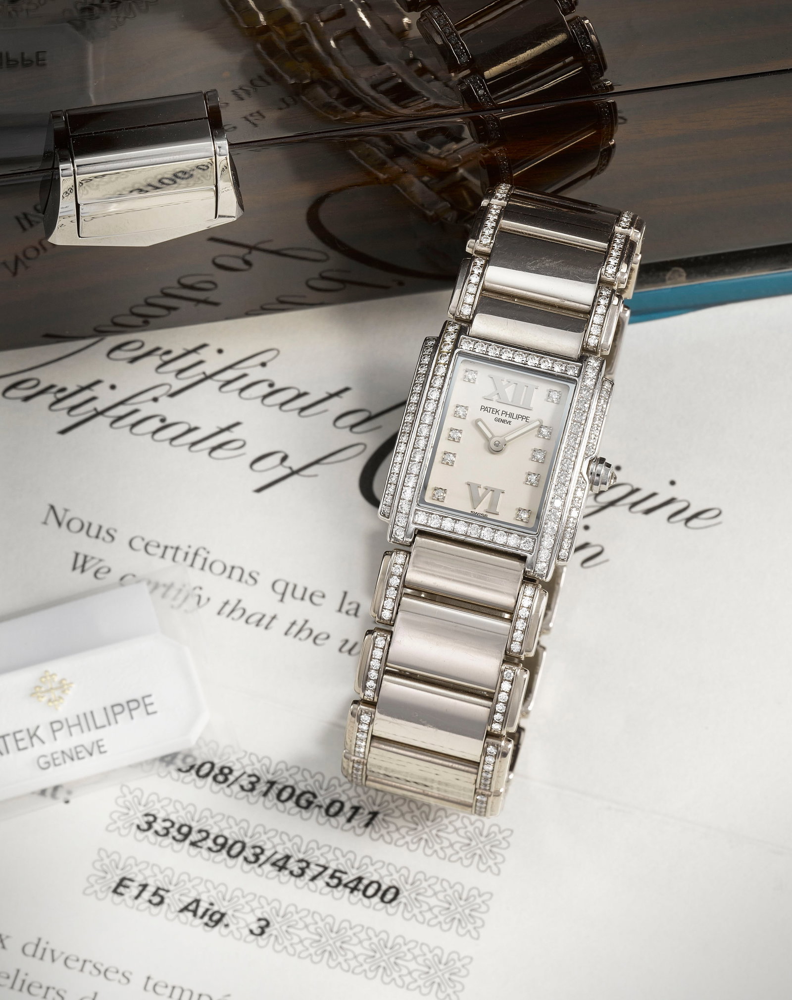 Patek Philippe. A fine lady's 18K white gold diamond set quartz bracelet watch Twenty 4, Ref: 49...: Patek Philippe. A fine lady's 18K white gold diamond set quartz bracelet watch Model: Twenty 4 Reference: 4908/310G-011 Date: Purchased 20th October 2006 Movement: 6-jewel Cal.E15 quartz, No.3392903 D