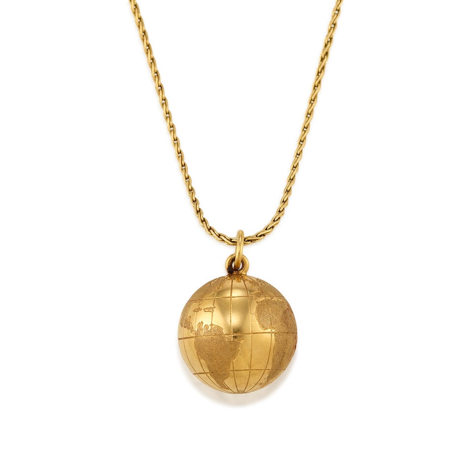 TIFFANY & CO.: 14K PENDANT WITH A 14K GOLD CHAIN: TIFFANY & CO.: 14K PENDANT WITH A 14K GOLD CHAIN • A 14K yellow gold pendant in the form of a globe, stamped TIFFANY & CO, GERMANY, measures 1 in. x 3/4 in. • A 14K yellow gold chain, not