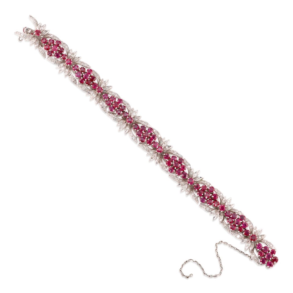 DIAMOND AND RUBY BRACELET: DIAMOND AND RUBY BRACELET • White precious metal alloy composed primarily of silver with palladium and minor gold content • Numerous round diamonds weighing approximately 1.35 - 1.45