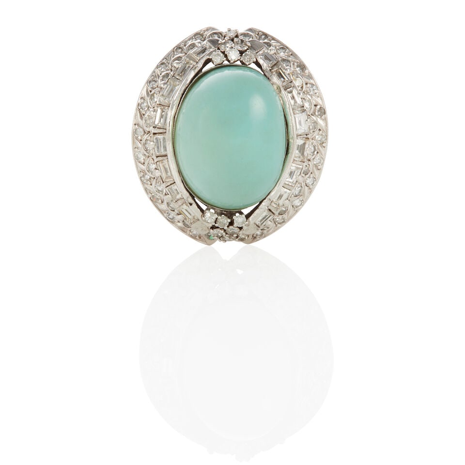 SILVER, DIAMOND AND TURQUOISE RING: SILVER, DIAMOND AND TURQUOISE RING • Silver • Numerous round and baguette diamonds 1.35 - 1.45 carat total • 1 oval turquoise cabochon measuring approximately 17.87mm x 13.87mm ̶