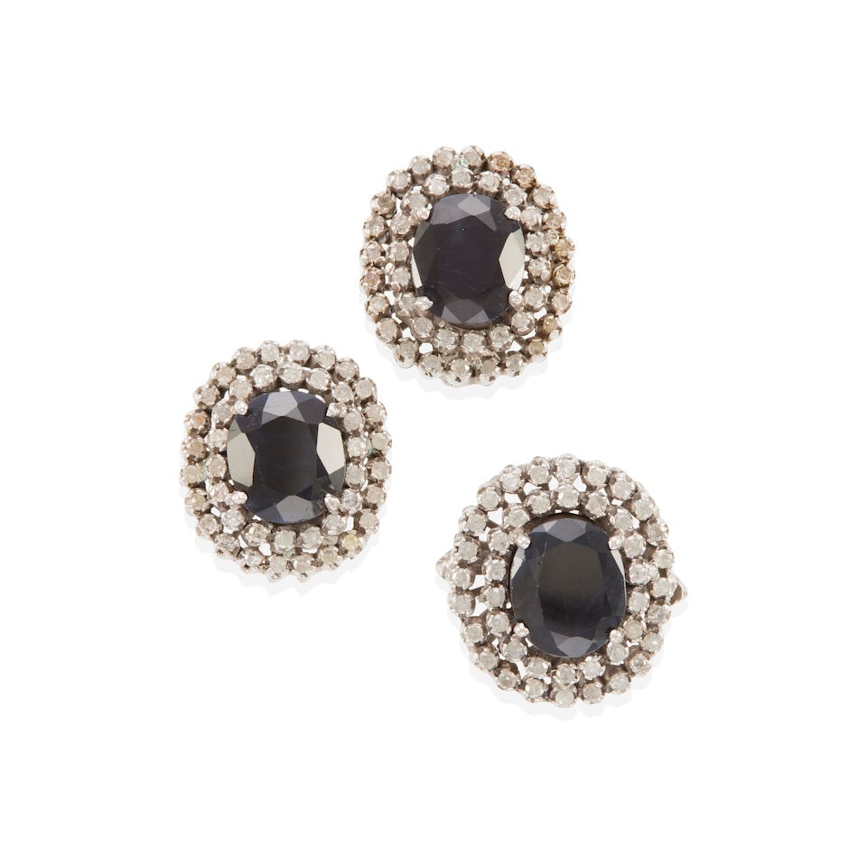 SAPPHIRE AND DIAMOND SET: SAPPHIRE AND DIAMOND SET • One pair of silver earrings with numerous round diamonds of decorative quality and 2 oval sapphires weighing approximately 6.20 - 6.30 carats total, measures 3/4 x