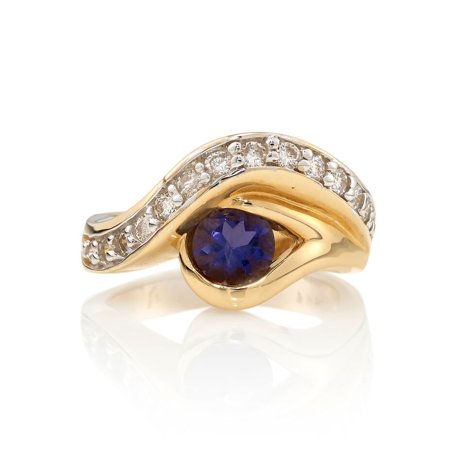 14K GOLD, TANZANITE, AND DIAMOND RING: 14K GOLD, TANZANITE, AND DIAMOND RING • 14K yellow gold • One round shaped tanzanite weighing approximately 0.75 carat • Numerous round shaped diamonds weighing approximately 0.15 ca