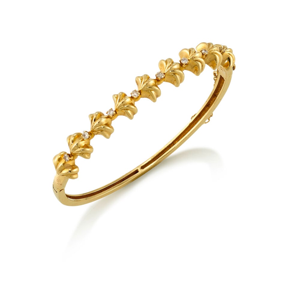 13K GOLD AND DIAMOND BANGLE: 13K GOLD AND DIAMOND BANGLE • 13K yellow gold • 8 round shaped diamonds weighing approximately 0.16 carat total • Inner circumference 6 1/2 in. • Estimated gross weight: 15.0