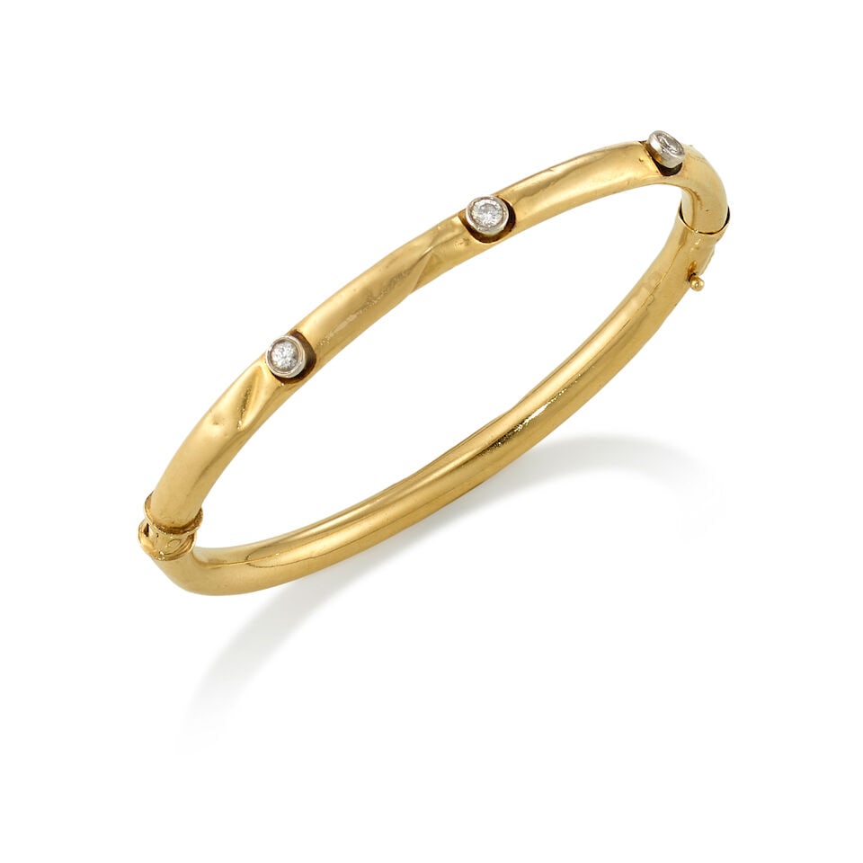 13K GOLD AND DIAMOND BANGLE: 13K GOLD AND DIAMOND BANGLE • 13K yellow gold • 3 round shaped diamonds weighing approximately 0.30 carat total • Inner circumference 6 1/2 in. • Estimated gross weight: 8.5 gr