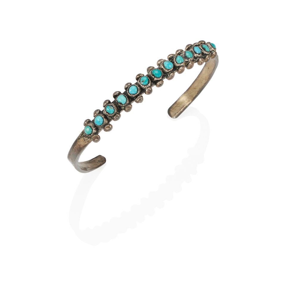STERLING SILVER AND TURQUOISE CUFF BRACELET: STERLING SILVER AND TURQUOISE CUFF BRACELET • Sterling silver • 13 round and near-round cabochon turquoise measuring approximately 3.0 mm • Inner circumference 6 1/4 in., gap 1