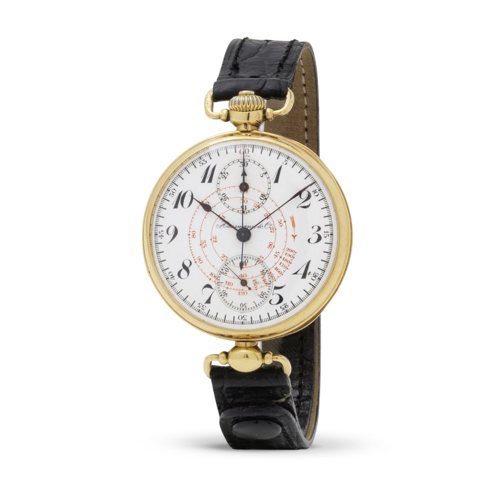 Hausmann & Co. A very rare and historical heavy 18K gold single pusher chronograph wristwatch wi...: Hausmann & Co. A very rare and historical heavy 18K gold single pusher chronograph wristwatch with enamelled white dial Hausmann & Co. Beau et rare chronographe bracelet historique en or jaune 18K (75