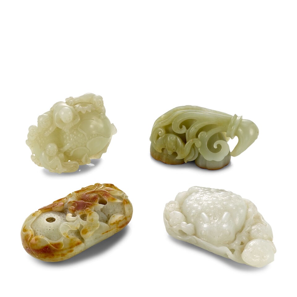 FOUR JADE CARVINGS OF ORNAMENTS 20th century (4): FOUR JADE CARVINGS OF ORNAMENTS 20th century Comprising: a lotus pod group; a children and pomegranate group; a toad on a giant leaf group; and a double gourd and carp group. Between 2 1/2in (6.3cm) a