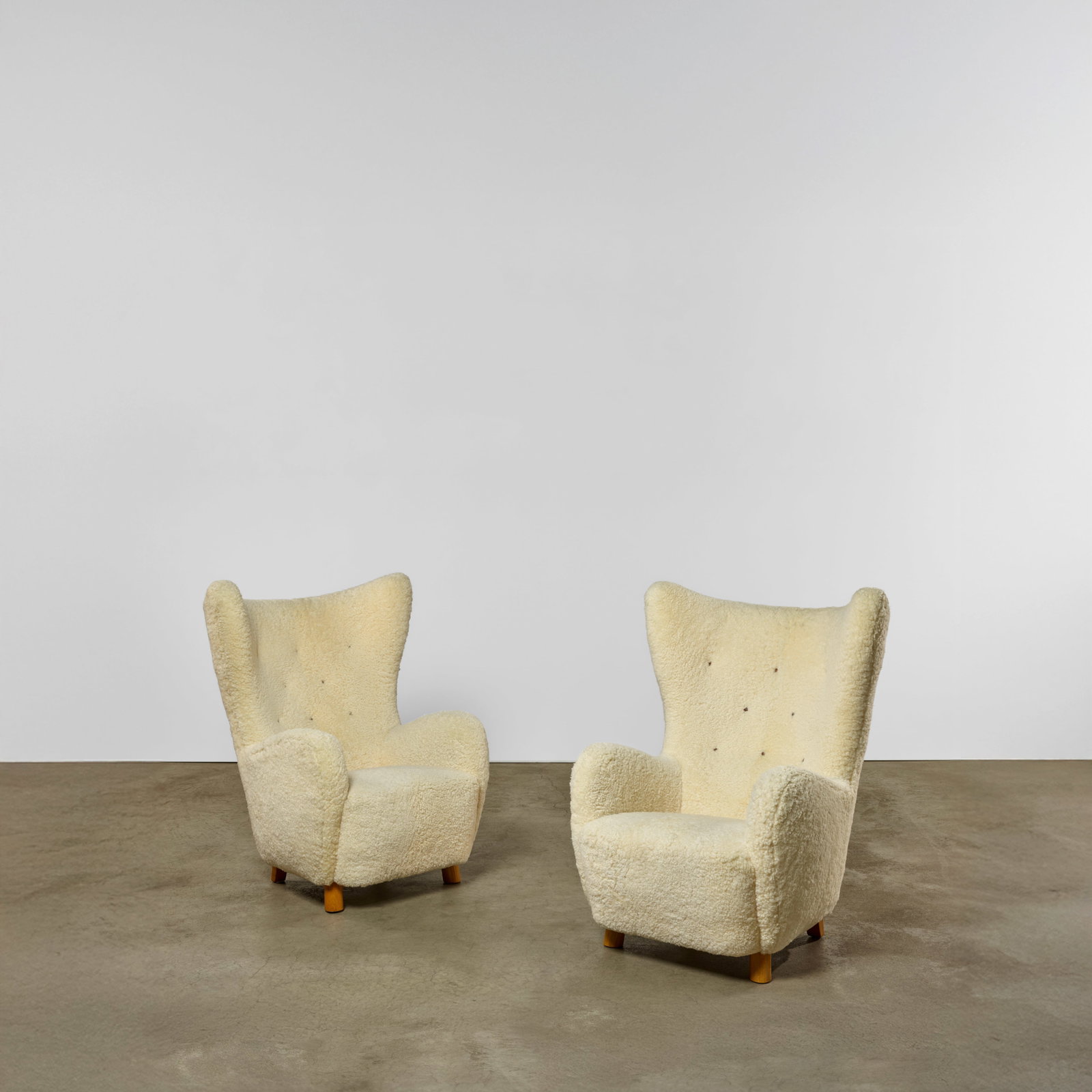MOGENS LASSEN (1901-1987) Pair of Wing Armchairscirca 1950sheepskin upholstery, oakheight 41 3/... (1 of 1)