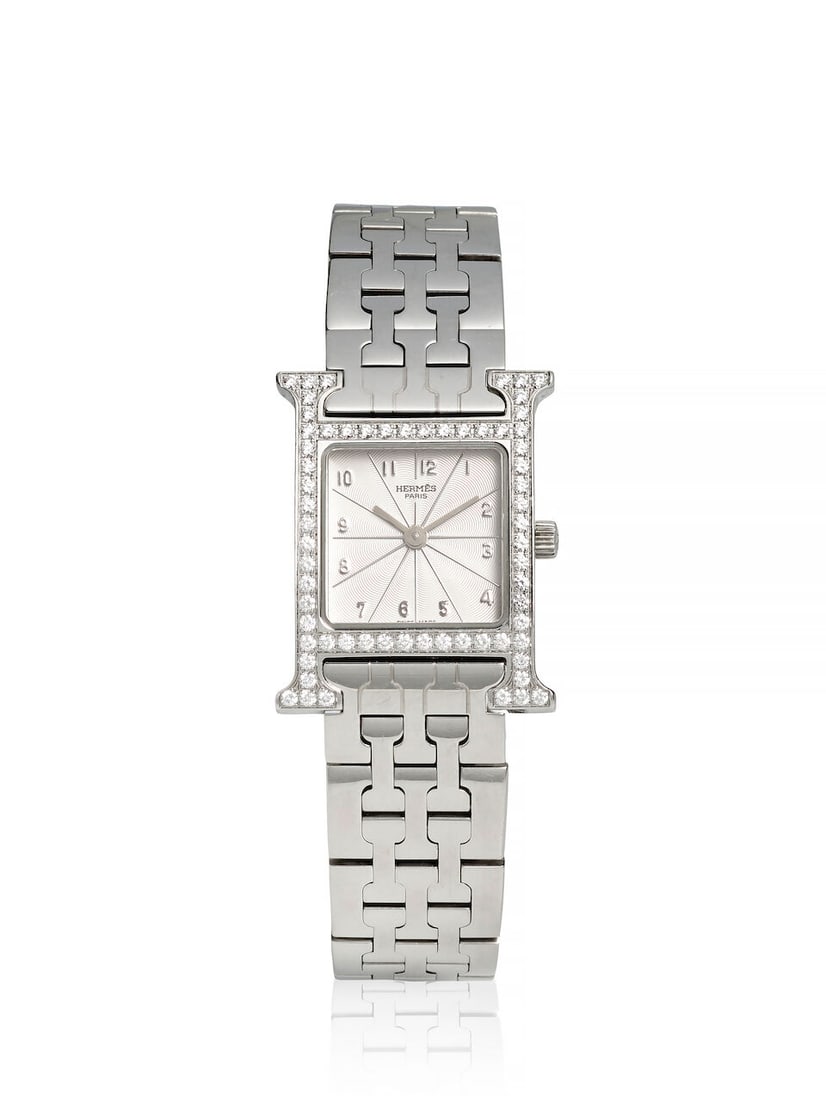 HERMES. A STAINLESS STEEL AND DIAMOND SET QUARTZ BRACELET WATCH Heure H, Ref: HH1.230, c. 2000s: HERMES. A STAINLESS STEEL AND DIAMOND SET QUARTZ BRACELET WATCH Model: Heure H Reference: HH1.230 Date: c. 2000s Movement: 3-jewel quartz Dial: Silvered Case: H form, case back secured by 4 screws, no