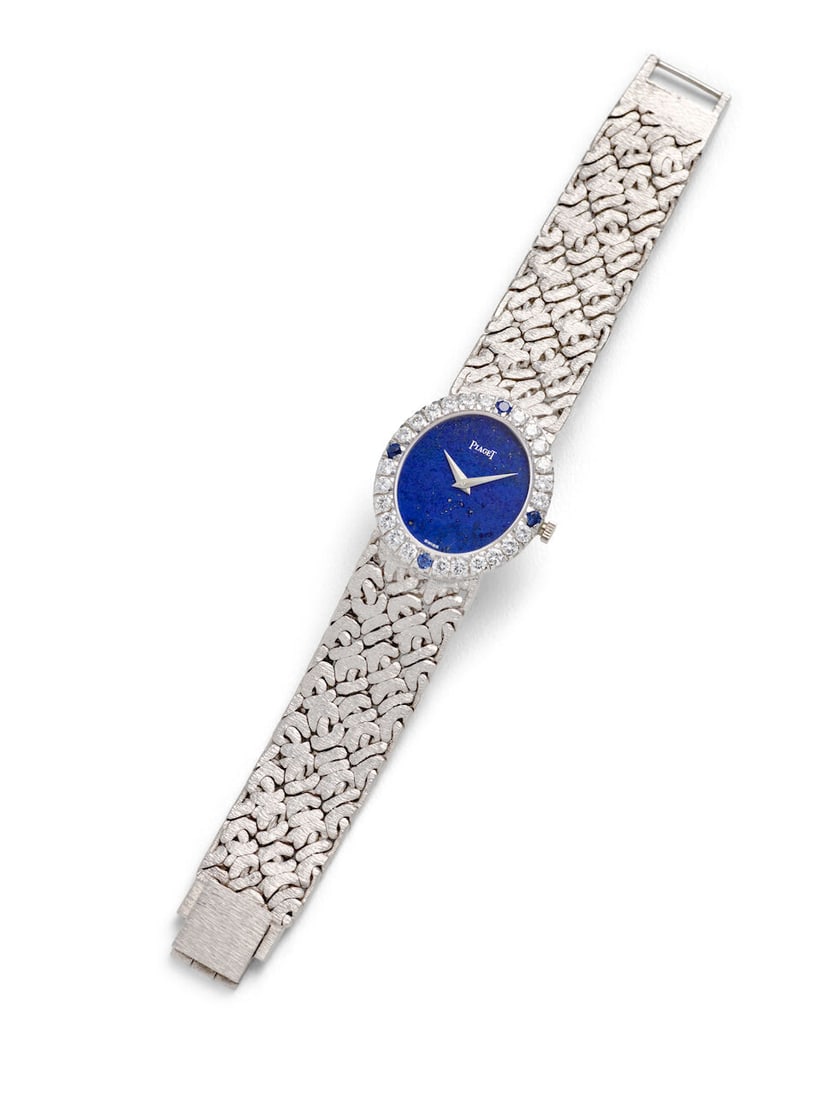 PIAGET. AN 18K WHITE GOLD, SAPPHIRE AND DIAMOND SET MANUAL WIND BRACELET WATCH Ref: 9814 N66, c....: PIAGET. AN 18K WHITE GOLD, SAPPHIRE AND DIAMOND SET MANUAL WIND BRACELET WATCH Reference: 9814 N66 Date: c. 1970s Movement: Cal. 9P, 18-jewel manual wind, no. 6890425 Dial: Lapis lazuli Case: Oval,