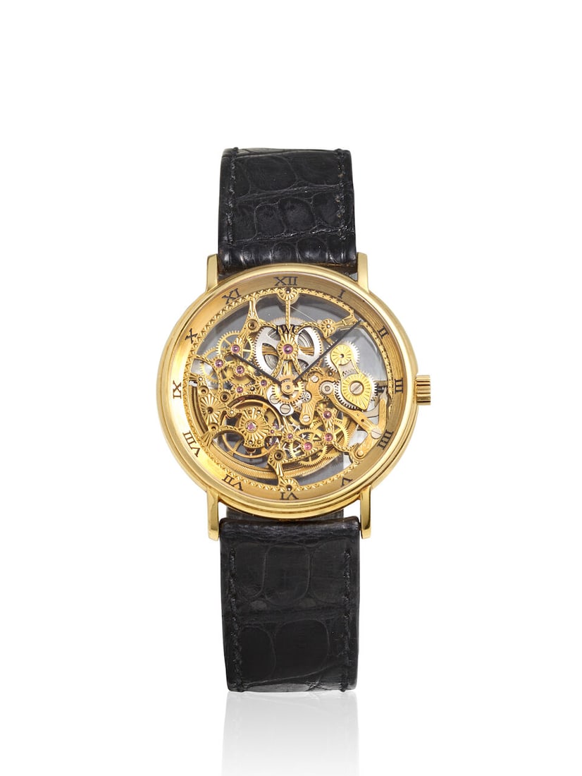 IWC. AN 18K GOLD SKELETONIZED AUTOMATIC WRISTWATCH Portofino, Ref: 2701, c. 1990s: IWC. AN 18K GOLD SKELETONIZED AUTOMATIC WRISTWATCH Model: Portofino Reference: 2701 Date: c. 1990s Movement: Cal. 2717, 34-jewel automatic, no. 2480313 Dial: Skeletonized Case: Round, snap on case