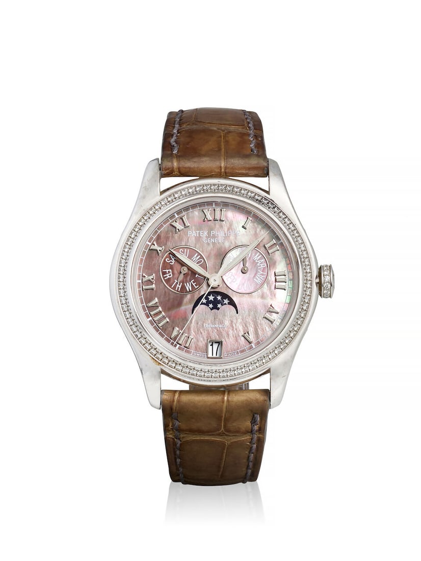 PATEK PHILIPPE, RETAILED BY TIFFANY & CO. AN 18K WHITE GOLD AND DIAMOND SET AUTOMATIC ANNUAL CAL...: PATEK PHILIPPE, RETAILED BY TIFFANY & CO. AN 18K WHITE GOLD AND DIAMOND SET AUTOMATIC ANNUAL CALENDAR WRISTWATCH WITH MOON PHASES AND MOTHER OF PEARL DIAL Model: Annual Calendar Reference: 4936G-001 D